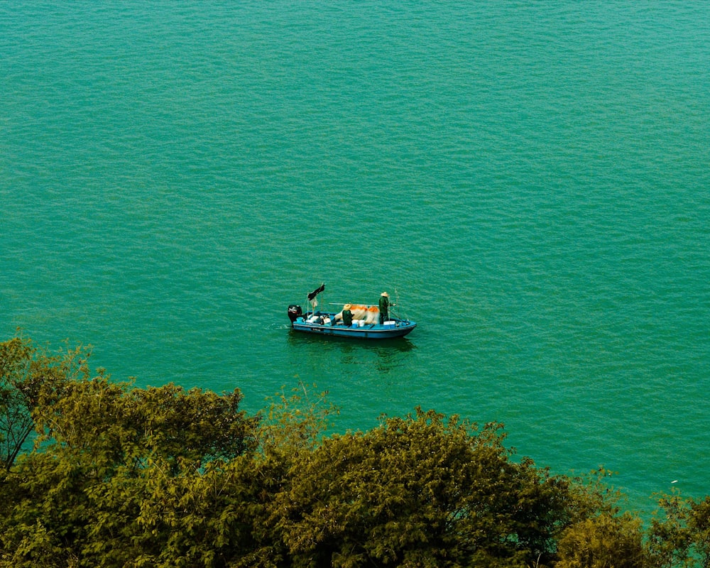 a small boat floating on top of a large body of water