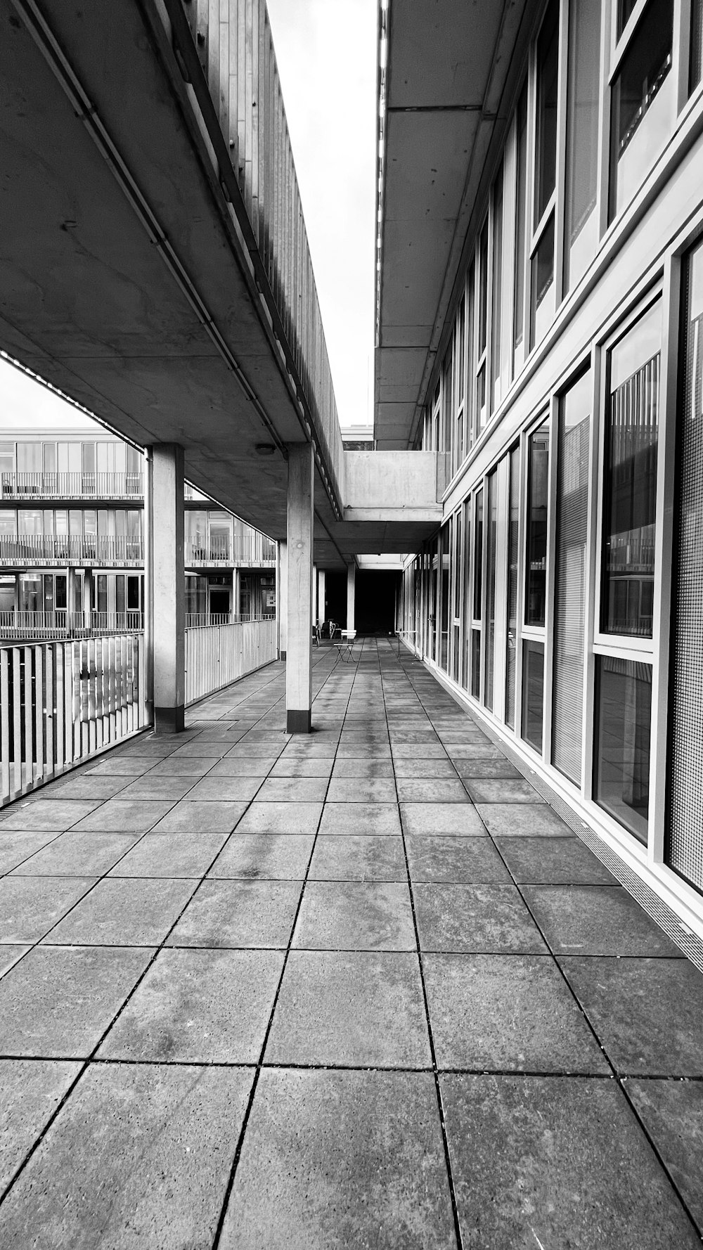 a black and white photo of an empty walkway