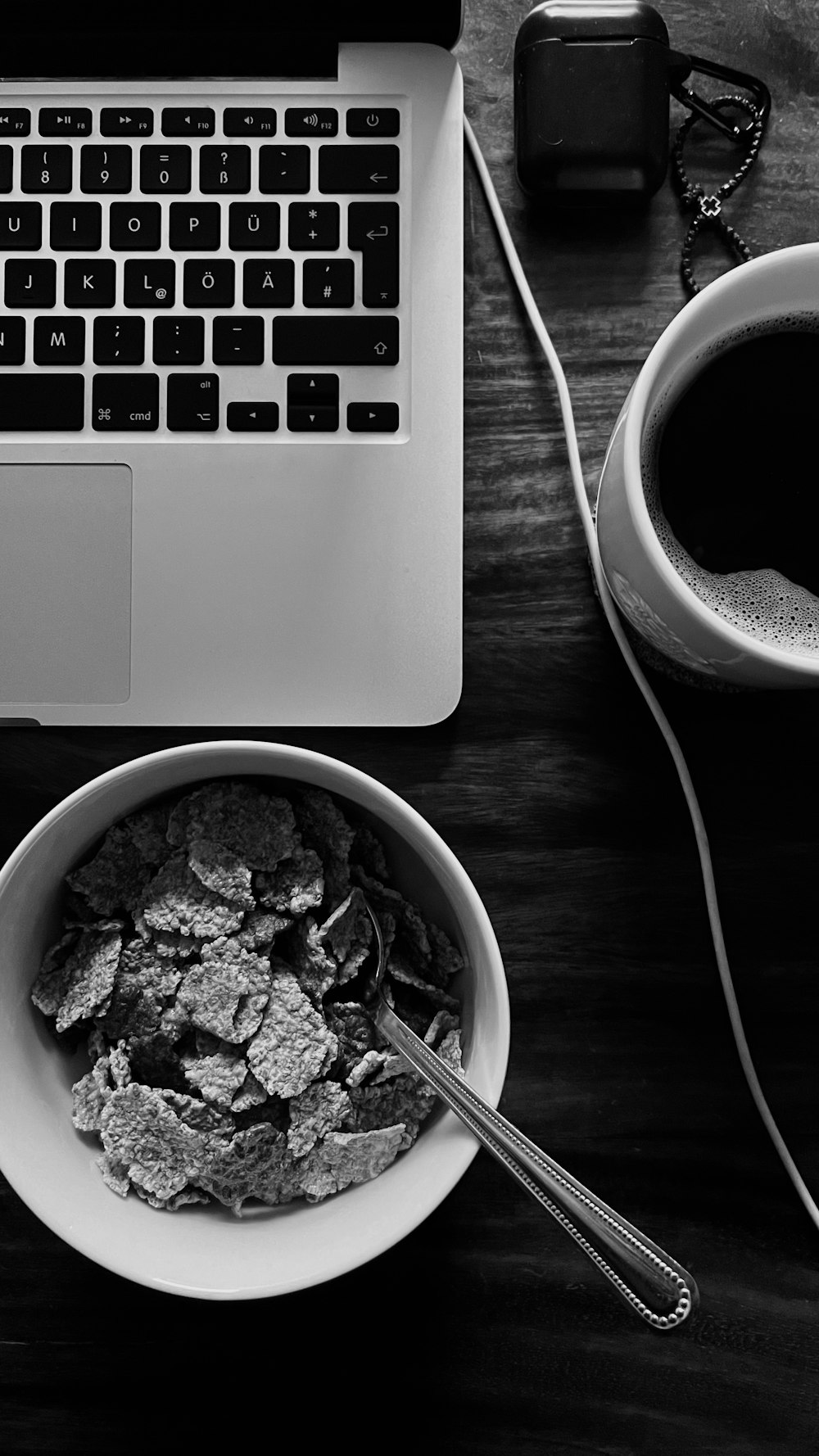 a bowl of cereal next to a laptop computer