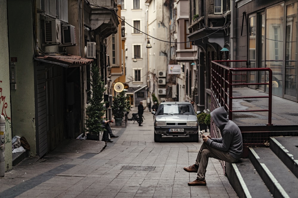 a man sitting on a bench looking at his cell phone