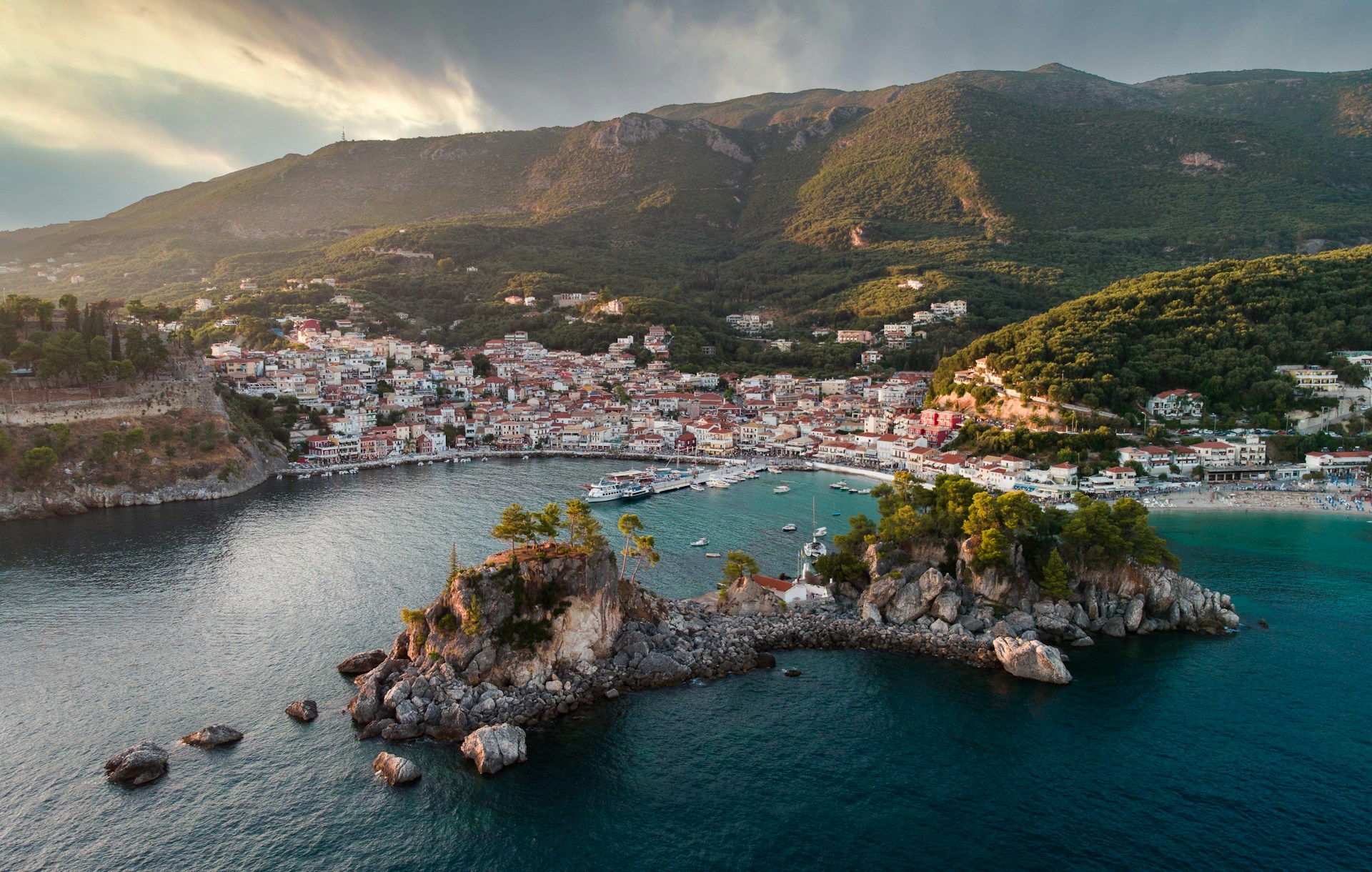 an aerial view of a town on a small island in the middle of the ocean