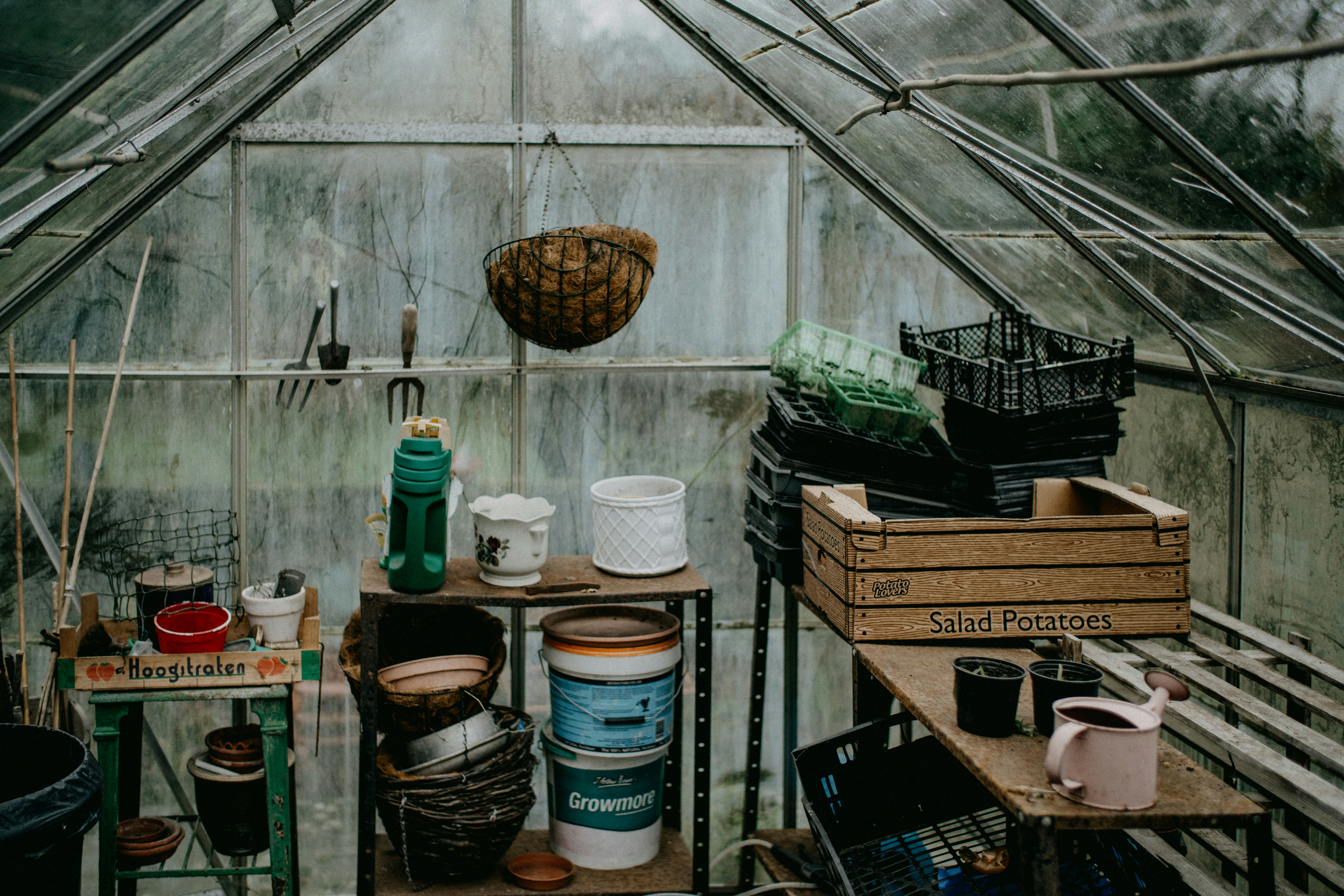 a greenhouse filled with lots of pots and containers