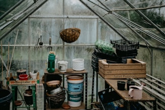 a greenhouse filled with lots of pots and containers