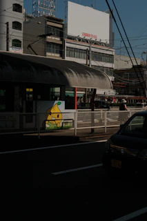 2D drawing of happy neighbors waiting together by a bus stop with shared vehicles arriving.