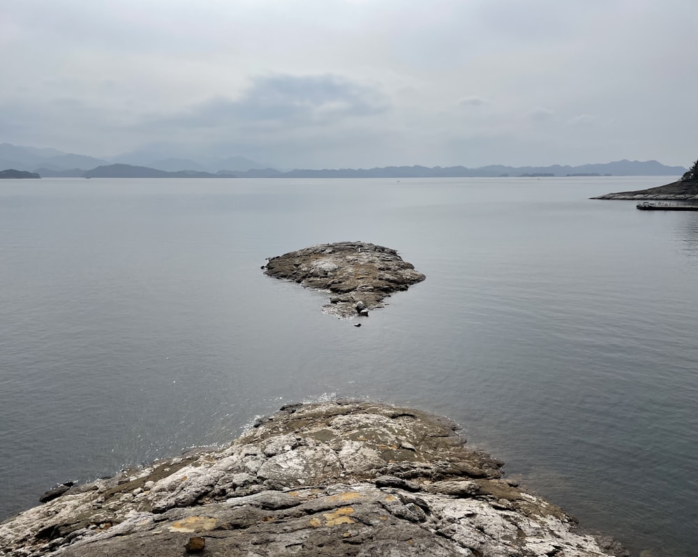 a rock outcropping in the middle of a body of water