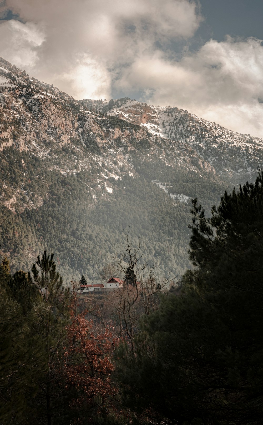 a view of a mountain with a house in the foreground