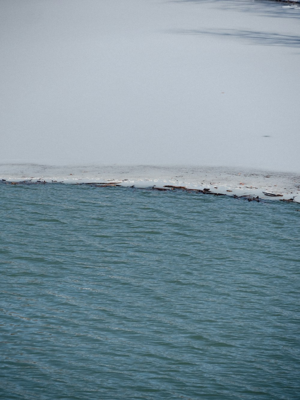 a large body of water with snow on it