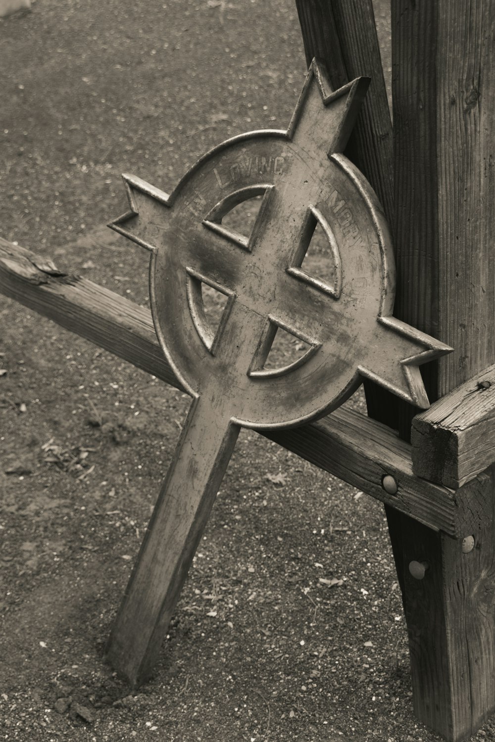 a close up of a wooden bench with a cross on it