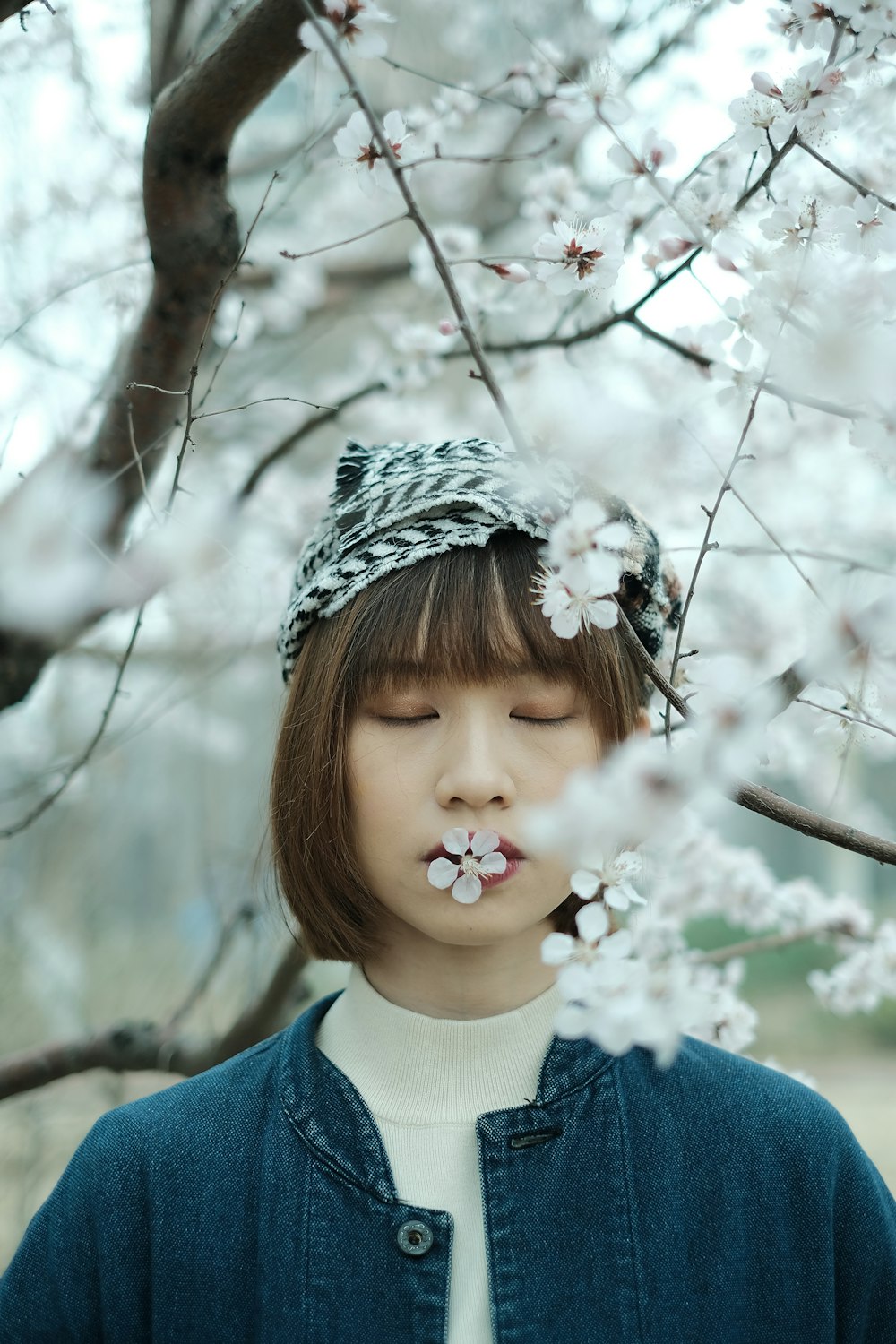 a young girl with a flower in her mouth