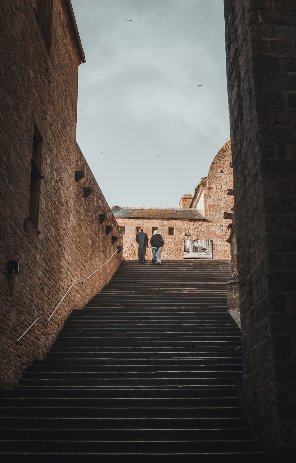 a couple of people that are walking up some stairs