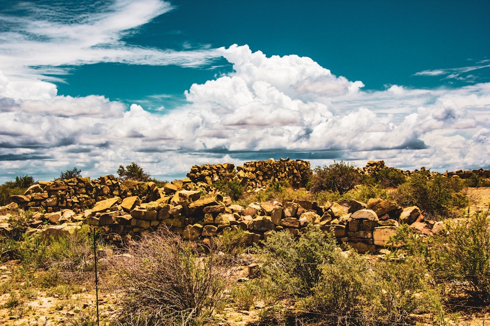 a large pile of rocks sitting in the middle of a field