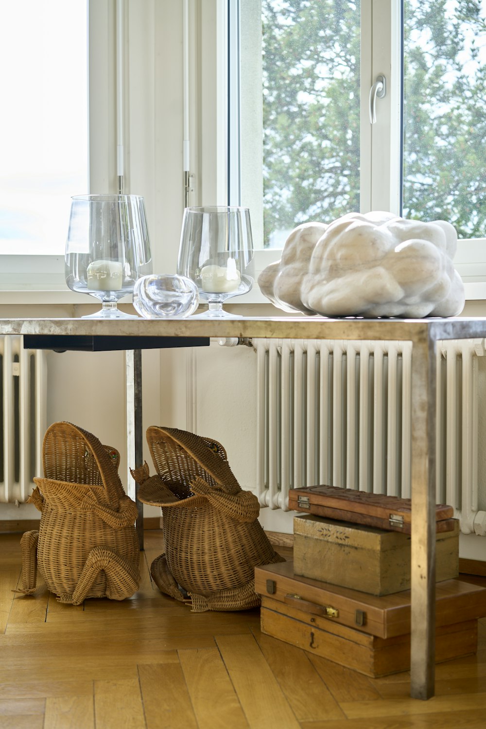 a wooden table topped with baskets and glasses