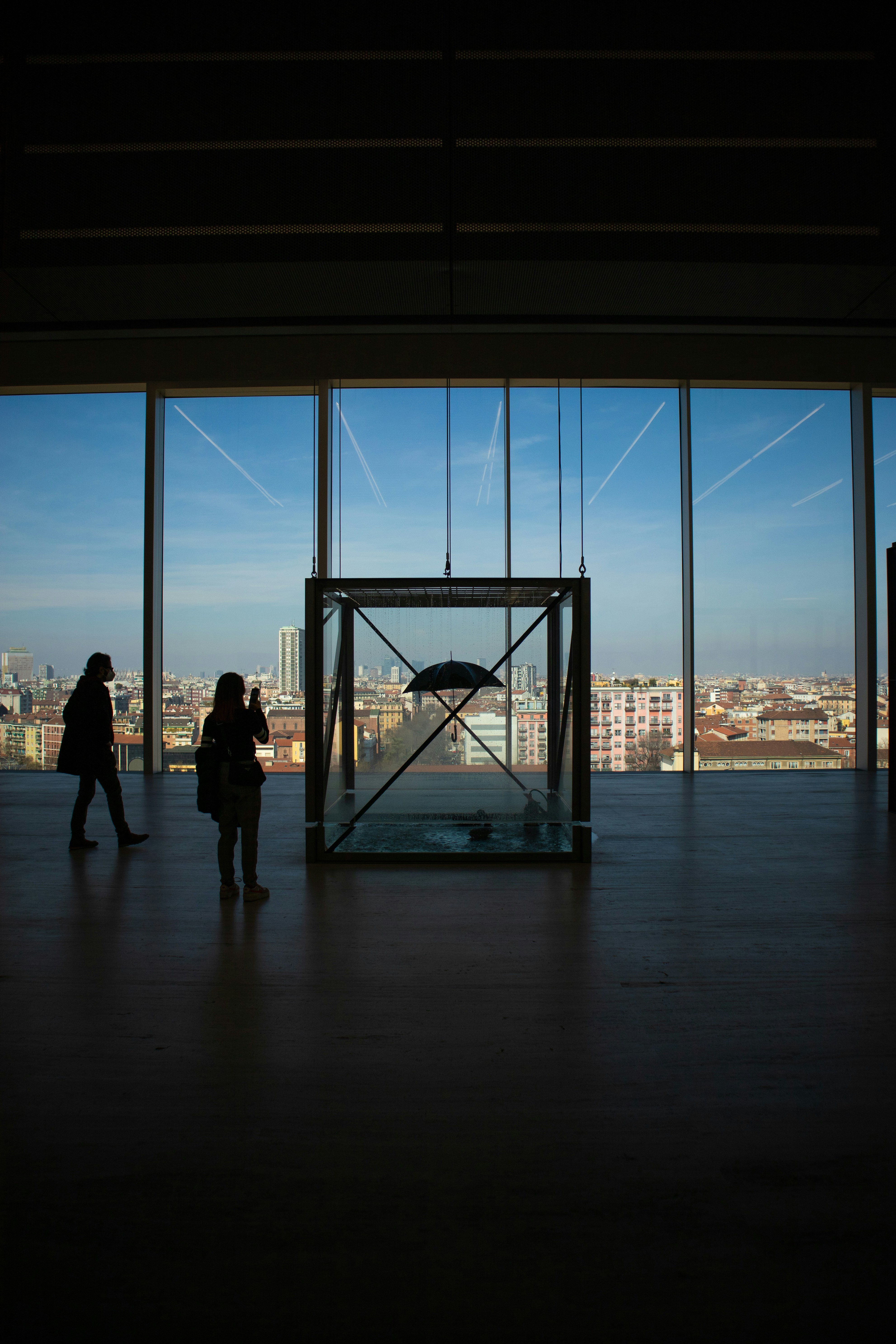 a couple of people standing in front of a window
