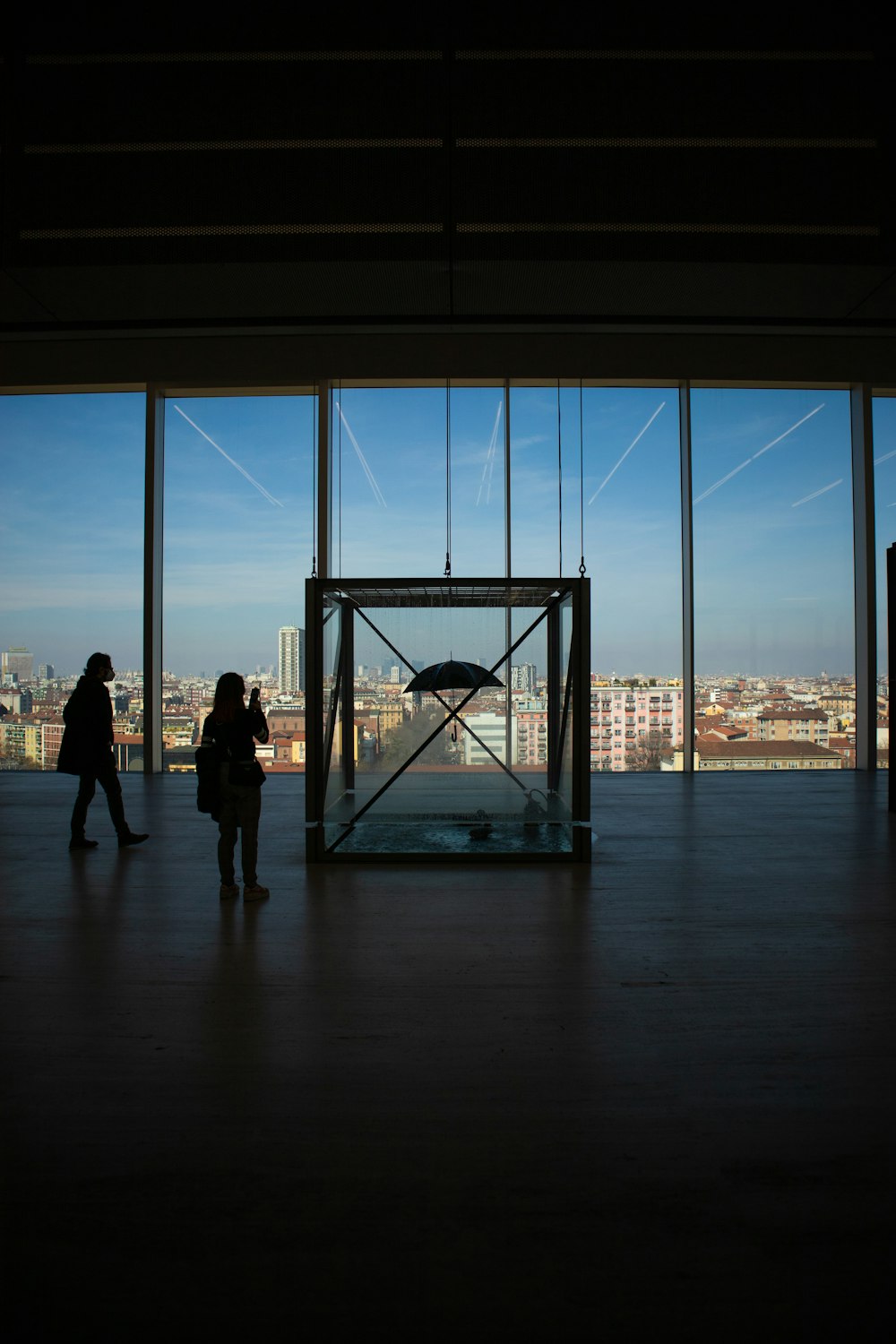 a couple of people standing in front of a window