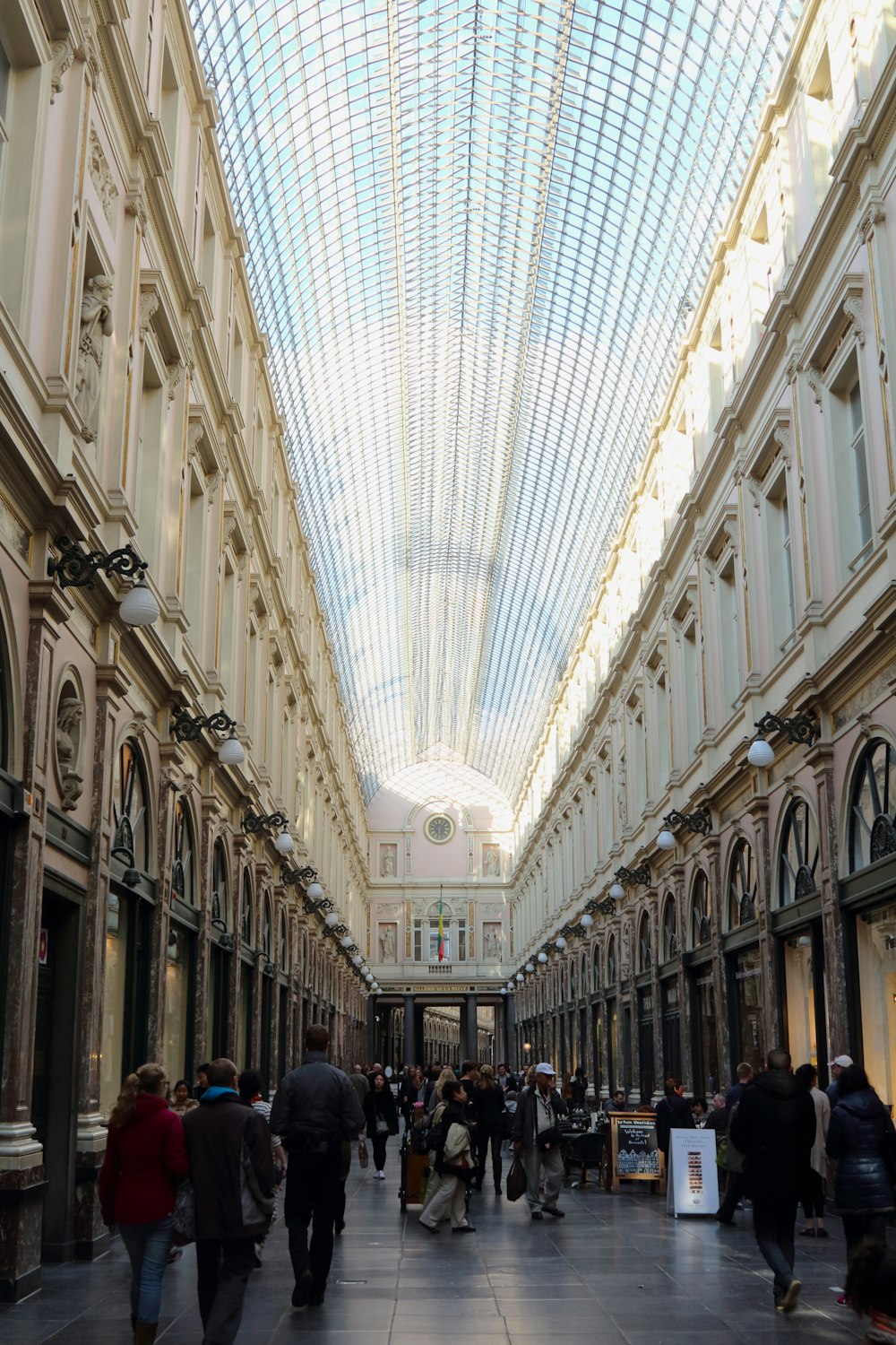 a group of people walking through a large building