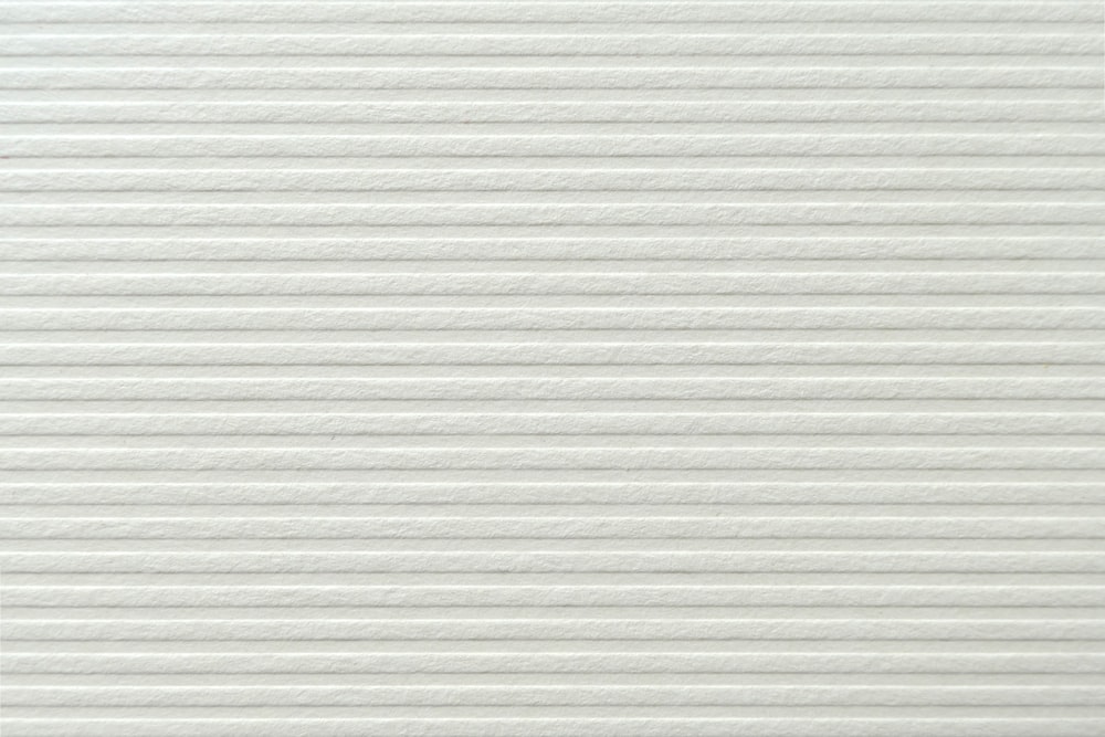 a close up of a white textured wall