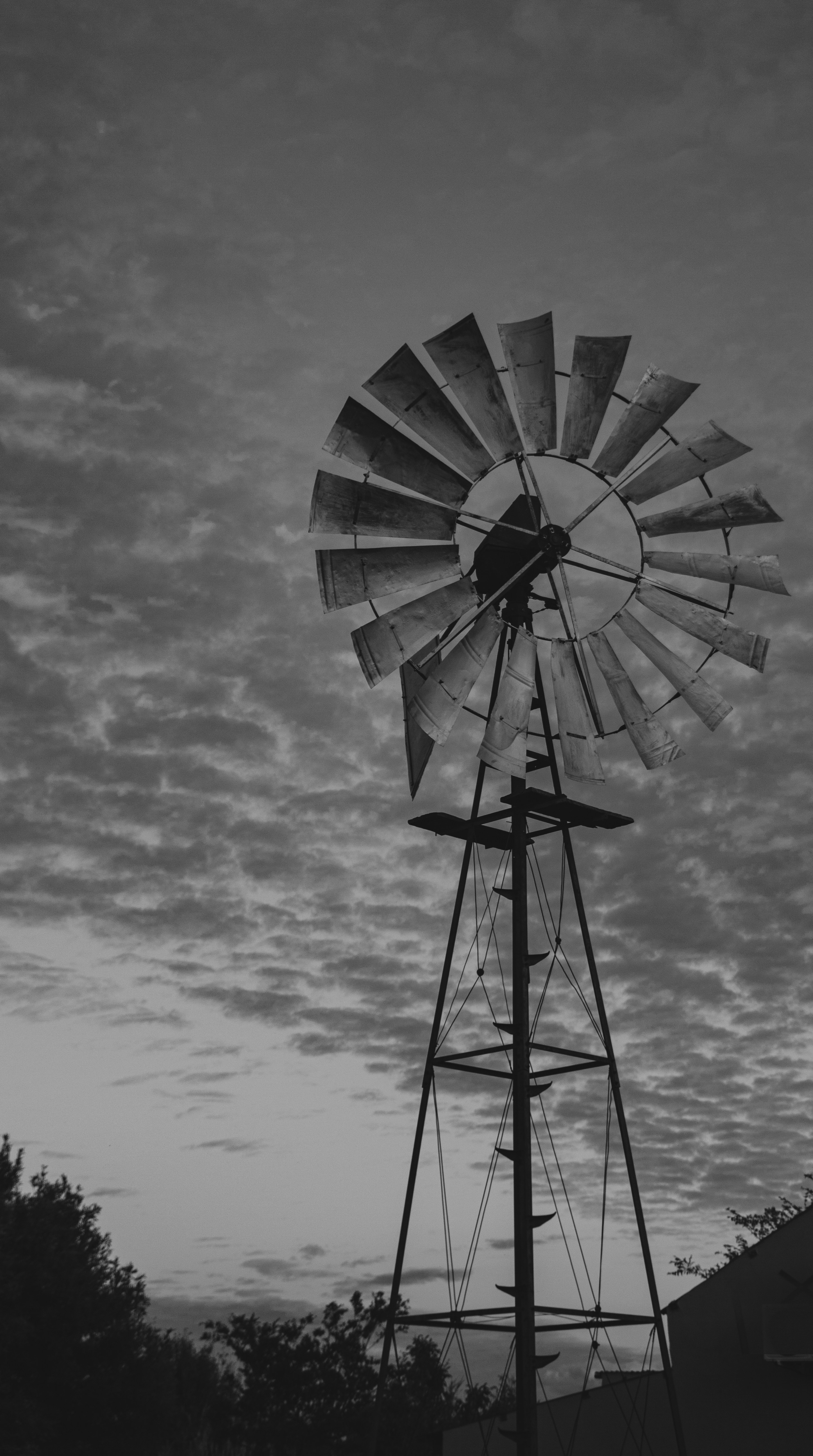 a black and white photo of a windmill