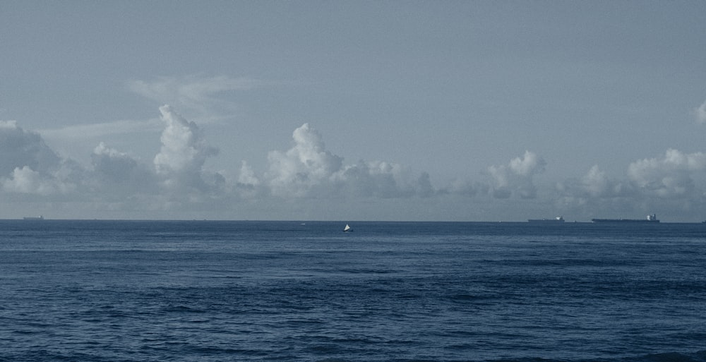 a large body of water surrounded by clouds