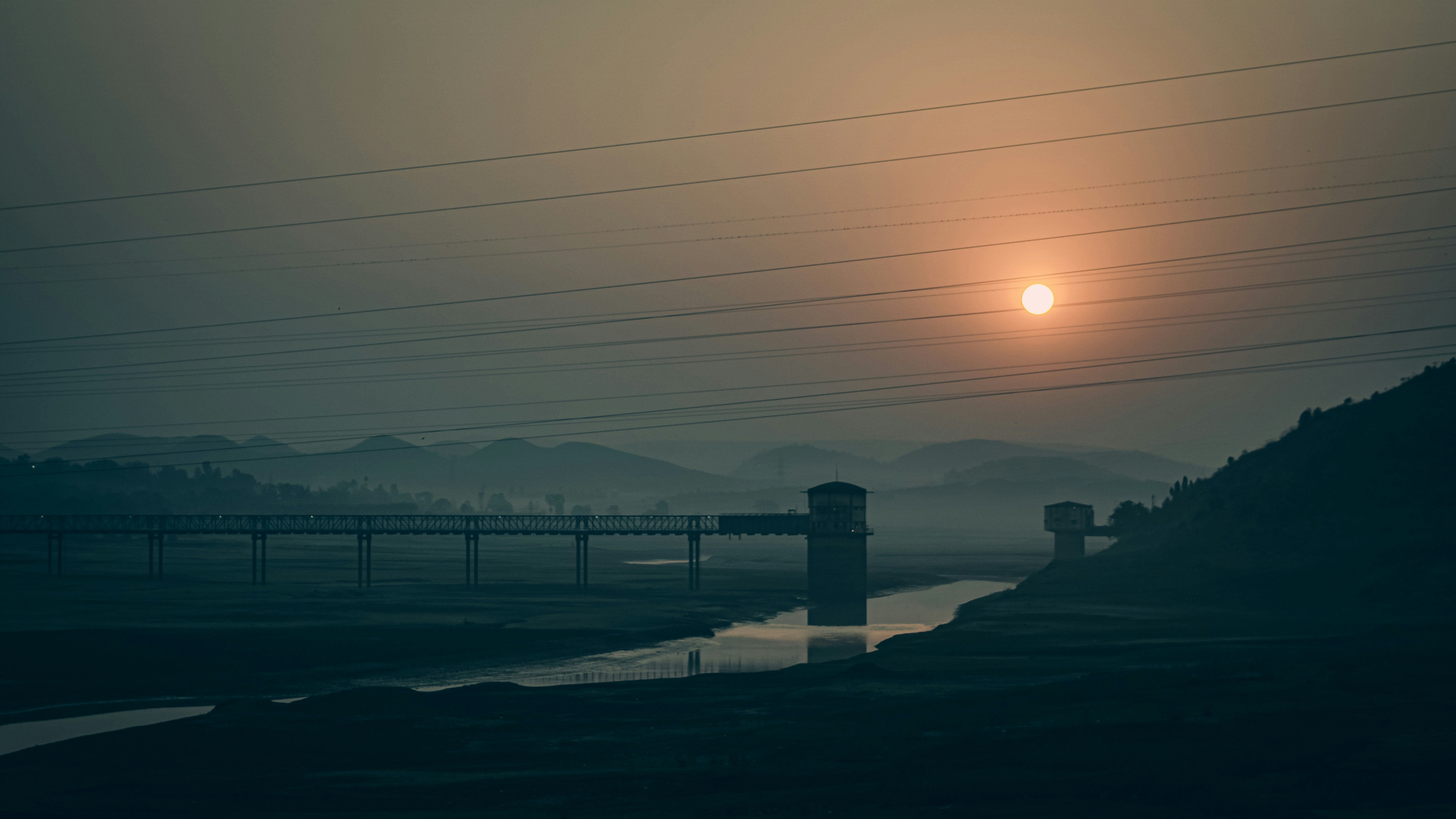 the sun is setting over a body of water