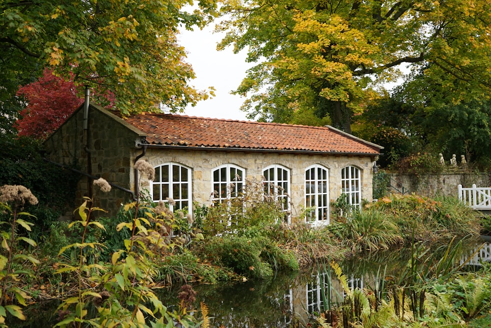 a small house sitting next to a body of water