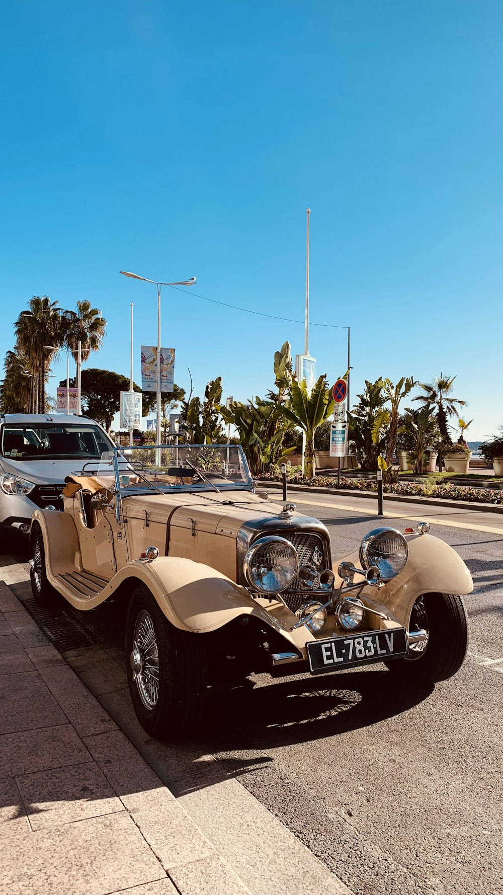 an old car parked on the side of the road