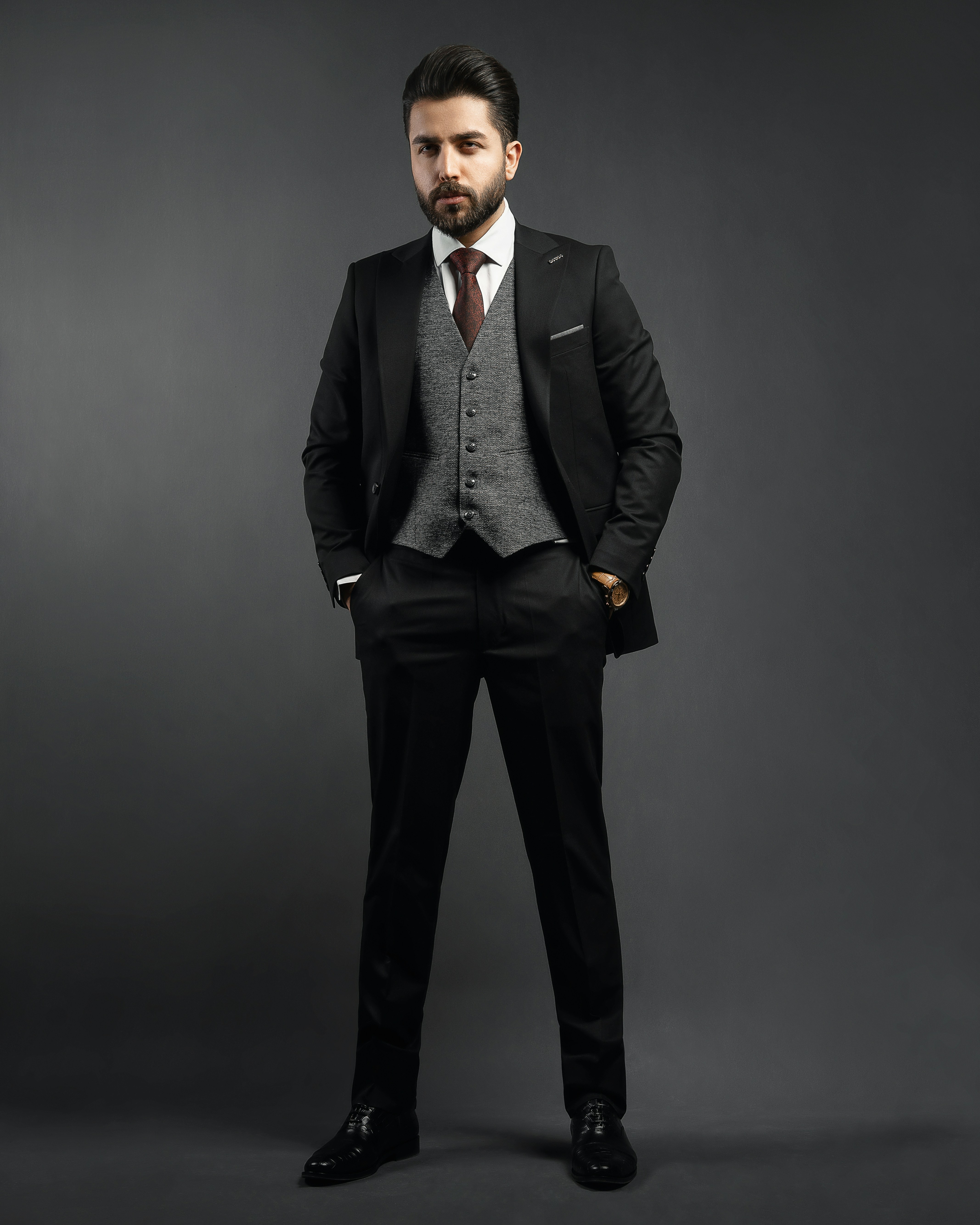 a man in a suit and tie posing for a picture