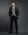 a man in a suit and tie posing for a picture