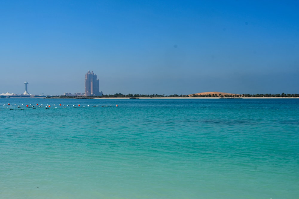 a large body of water with a tall building in the background