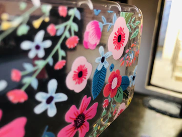 Close-up of painted kitchen towels featuring delicate floral designs.