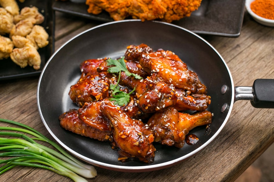 chinese honey garlic chicken glossy sticky glazed pieces served on a white plate with sesame seeds