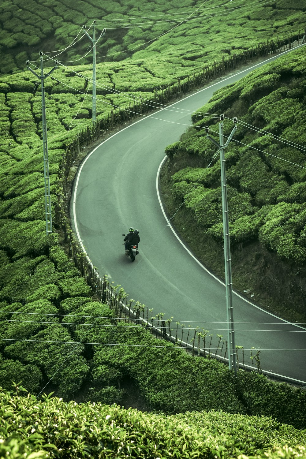 a motorcycle is driving down a winding road