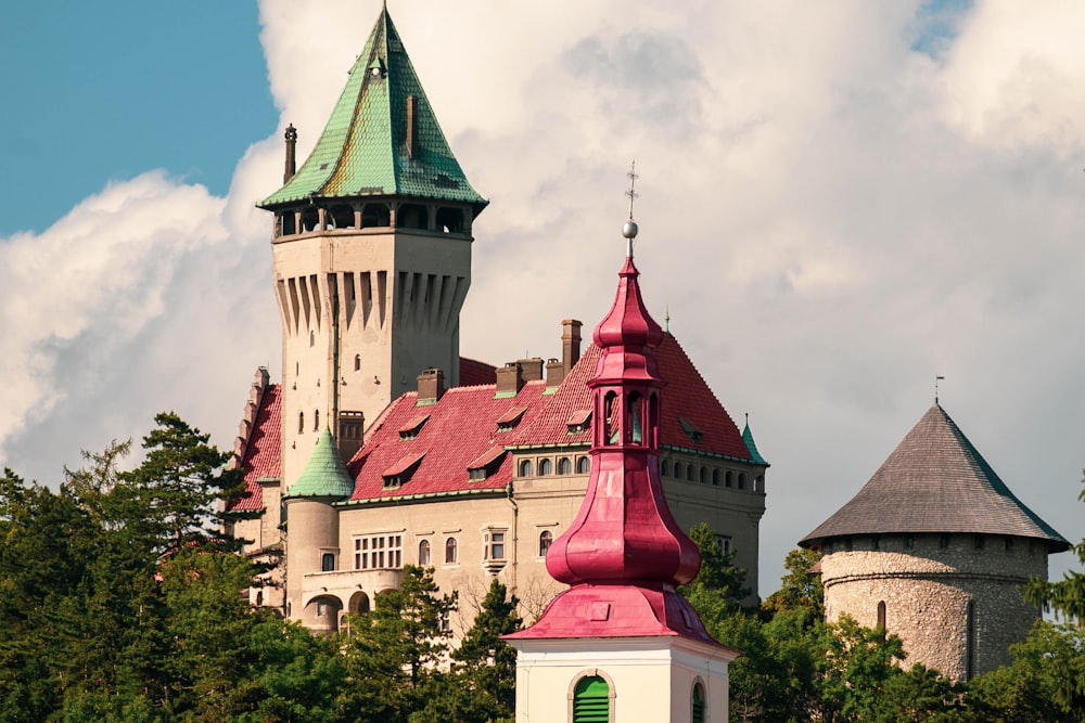 a large building with a green roof and two towers