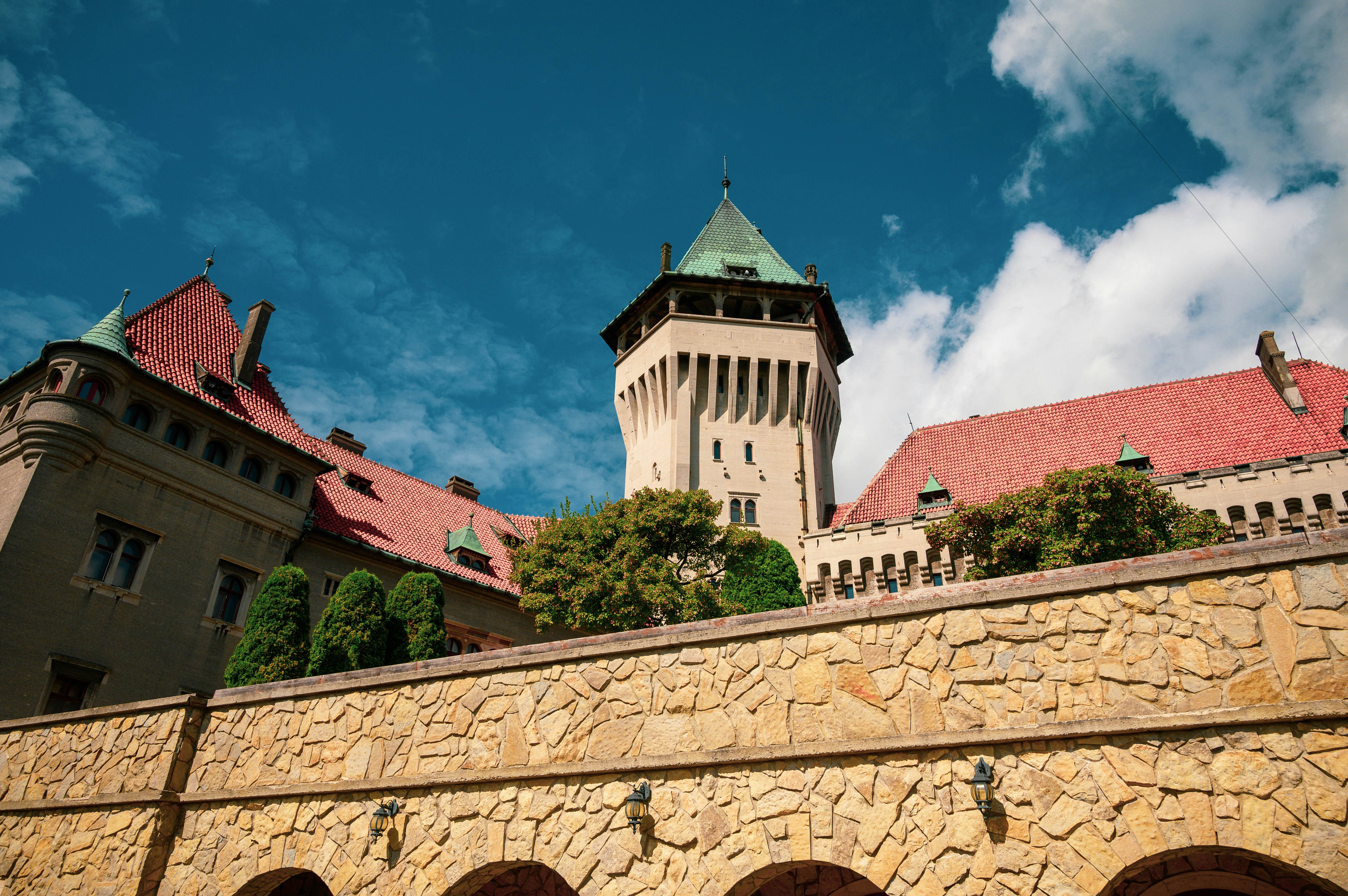 a stone wall with a clock tower in the background