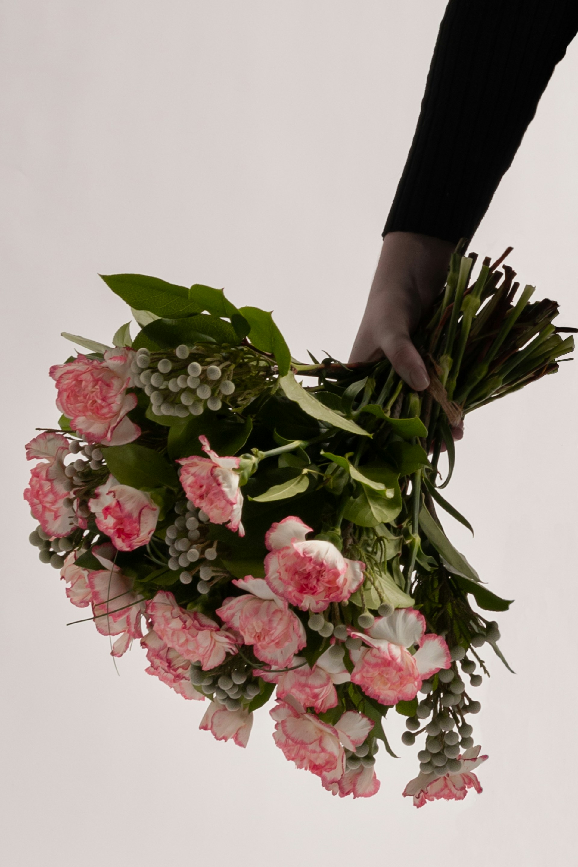 a person holding a bunch of flowers in their hand