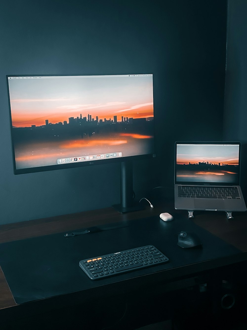 a desk with a laptop and a monitor on it
