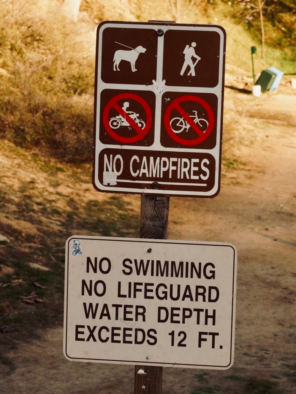 a sign warning of no swimming, no lifeguard, no water, and no