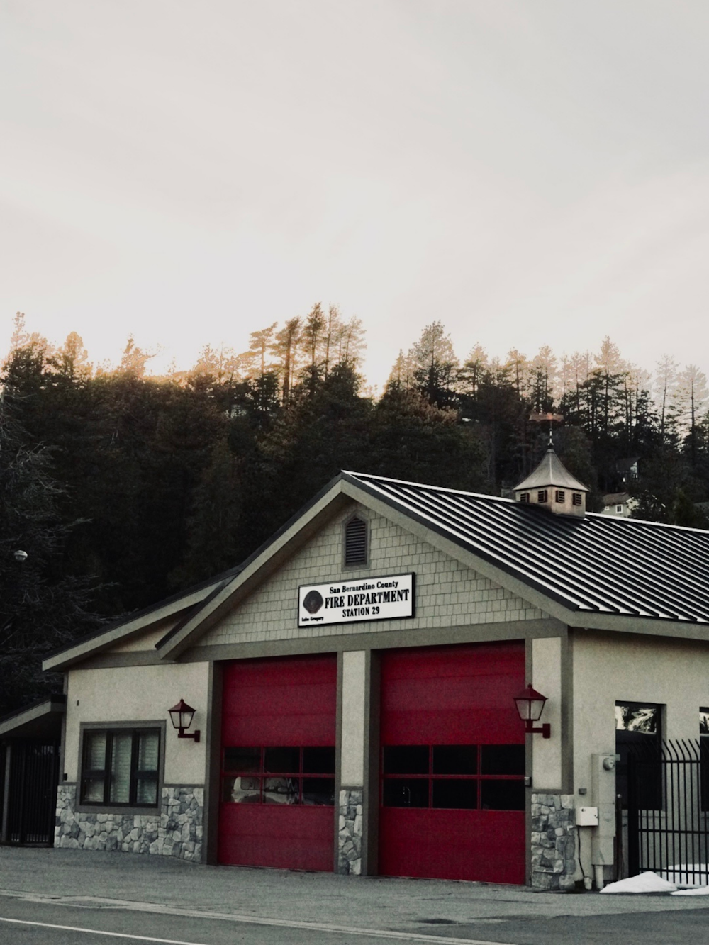 a fire station with a red fire hydrant in front of it