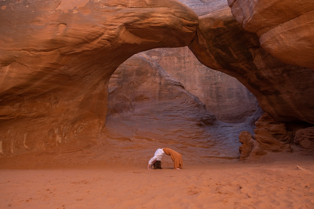 a person kneeling down in the middle of a desert