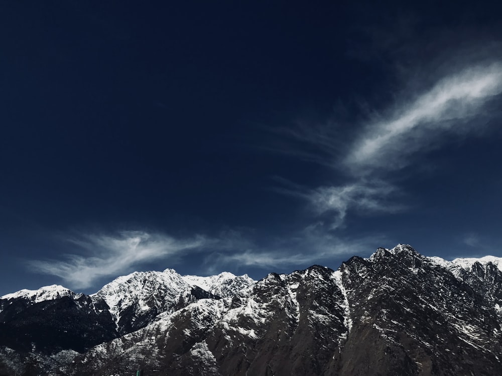 a view of a mountain range with snow on it