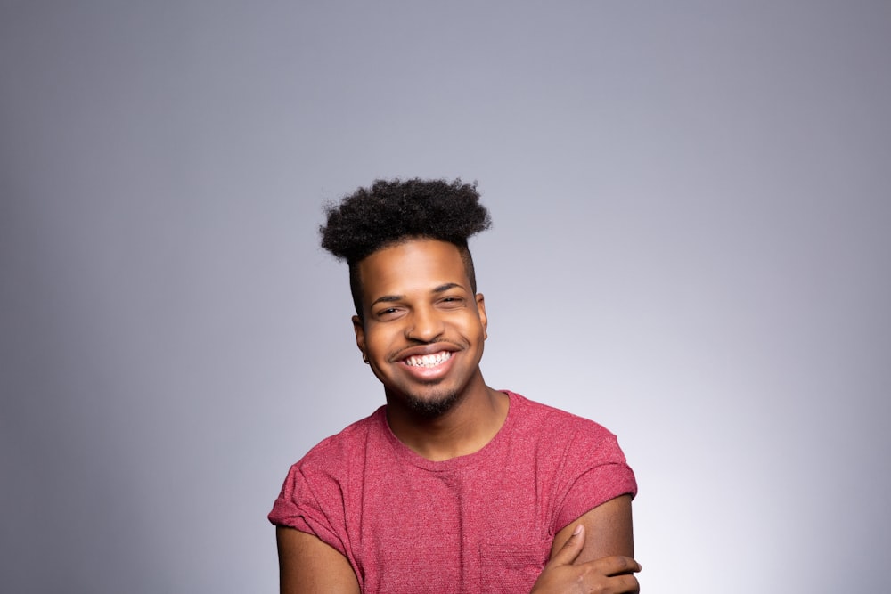 a smiling man with his arms crossed