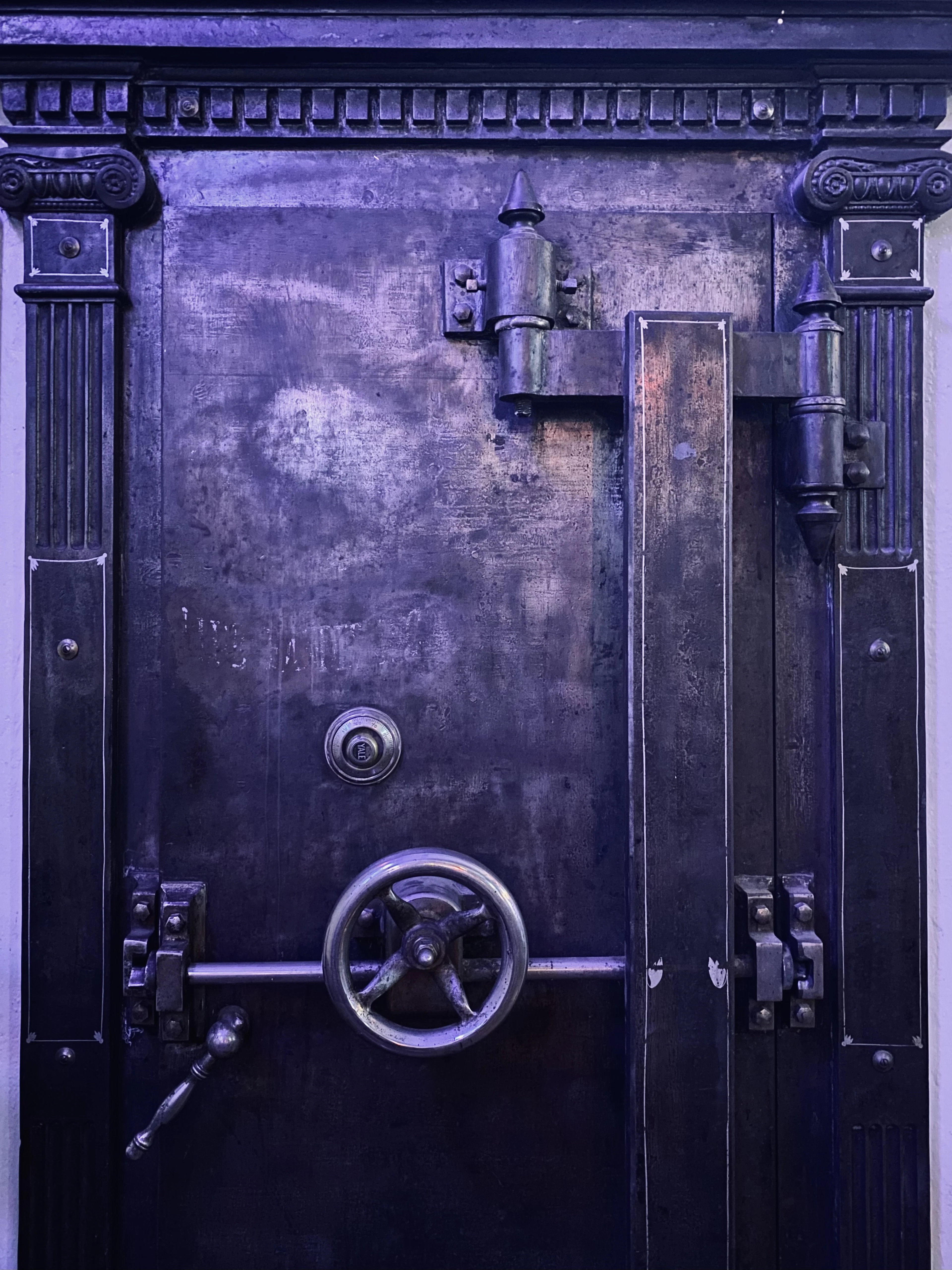 An old steel vault door with a locking wheel
