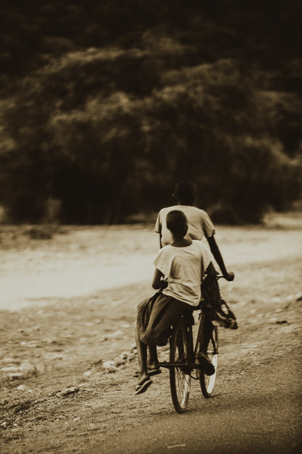 a couple of people riding on the back of a bike