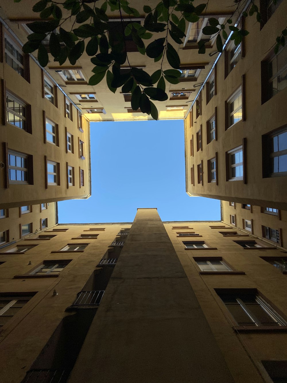 a tall building with windows and a sky in the background