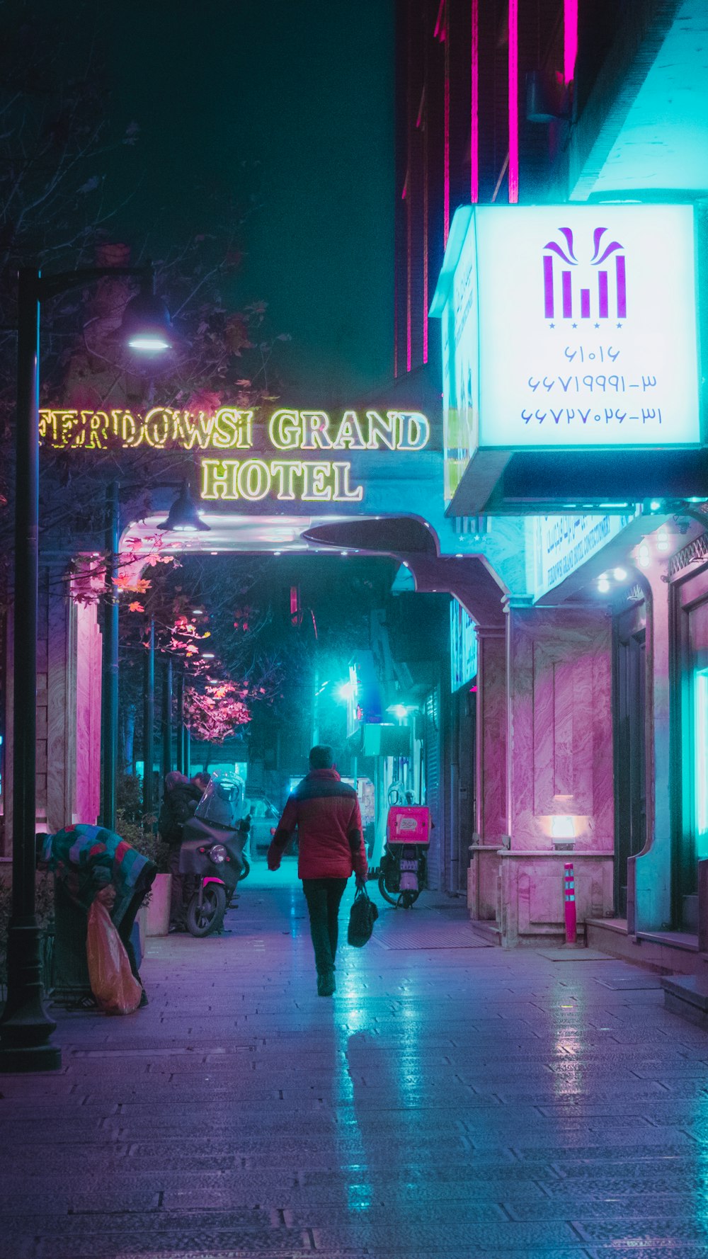 a person walking down a street at night