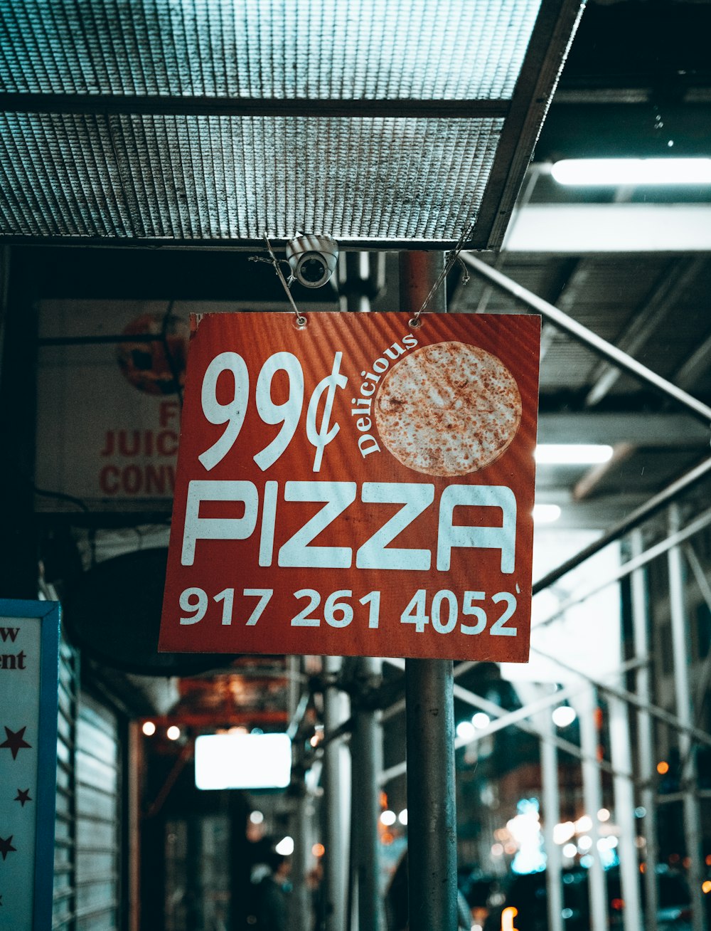 a red sign that says 99 off pizza