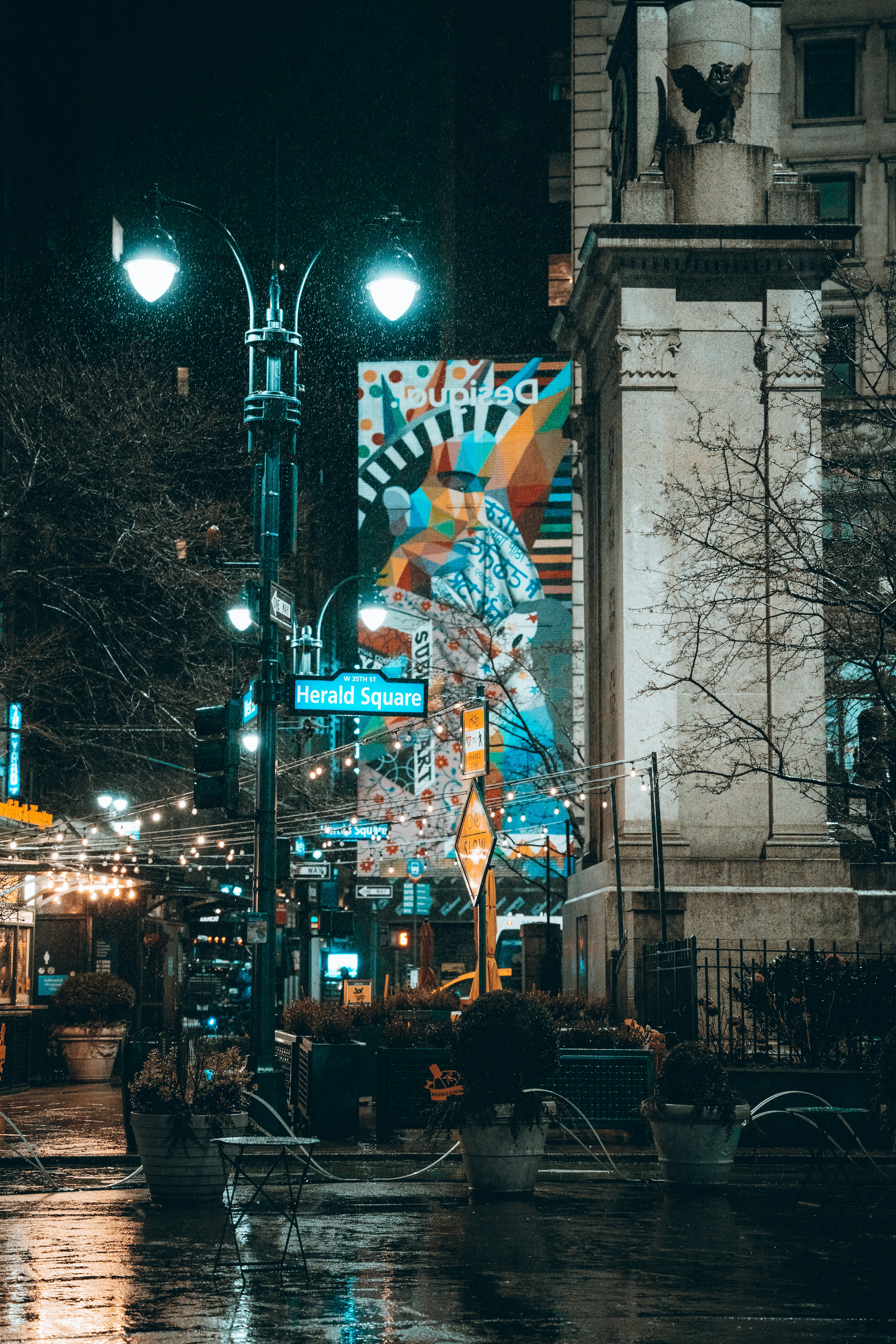 A city street at night with street lights and street signs photo – Free ...