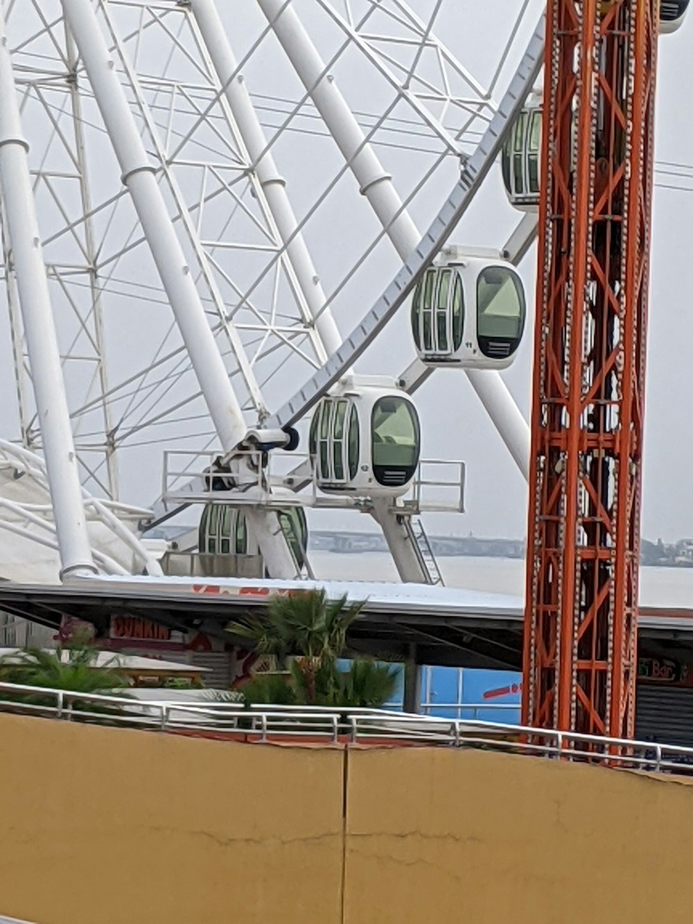 a large ferris wheel sitting next to a building