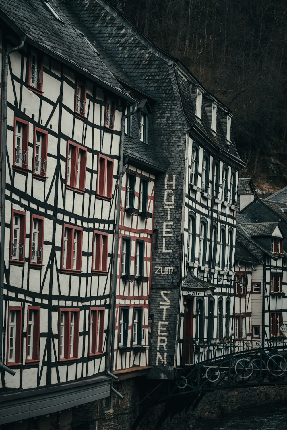 a row of buildings with red and white windows