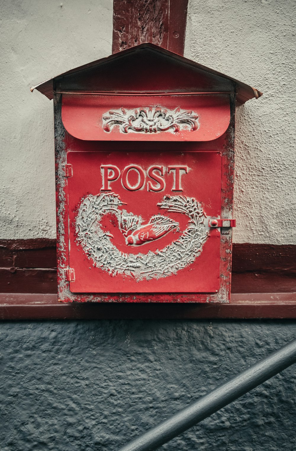 a red mailbox with a dragon painted on it