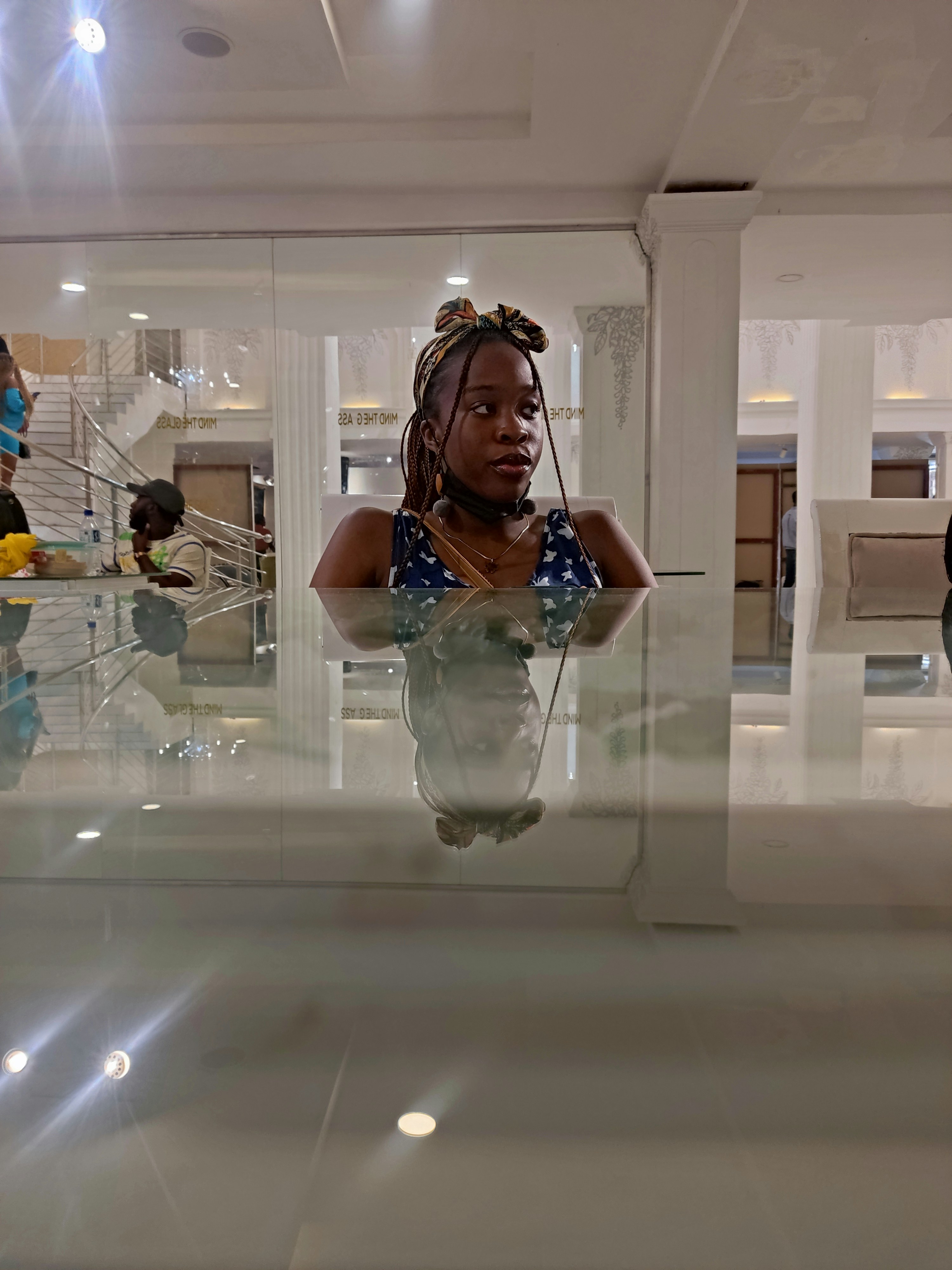 a woman is reflected in a mirror in a building